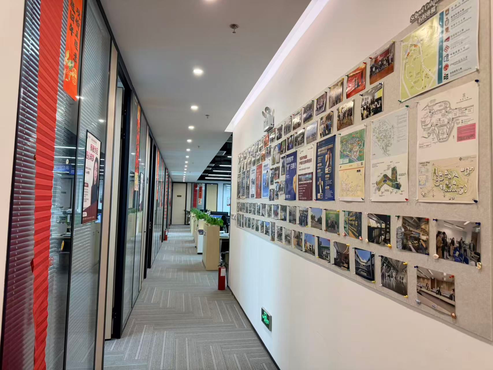 Office corridor with photographs of activities and visits on the wall