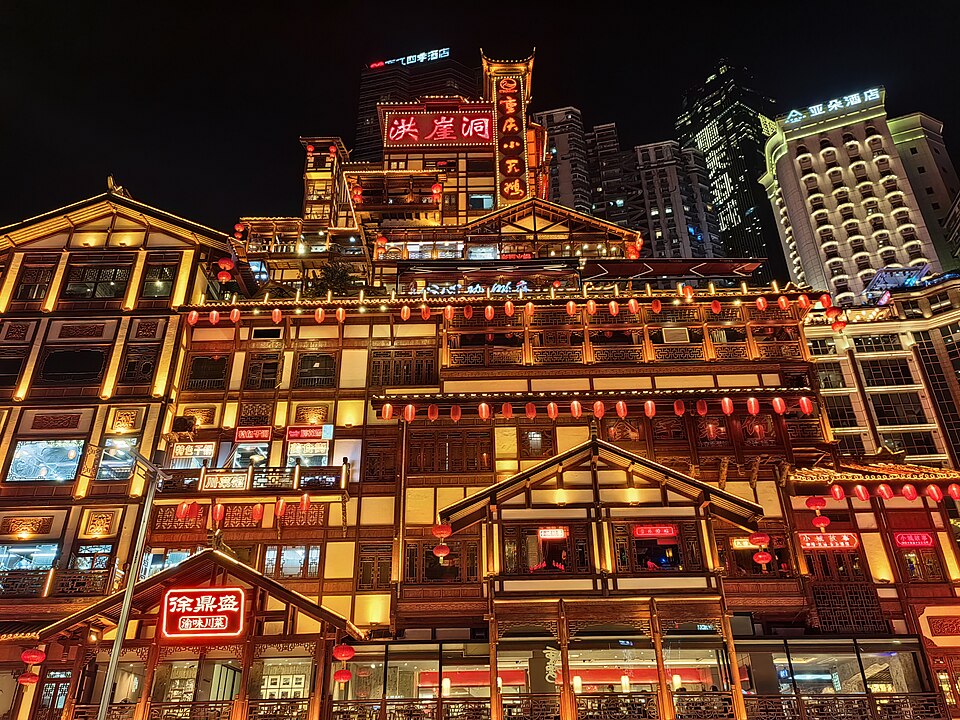 The illuminated riverside architecture of Hongya Cave in Chongqing